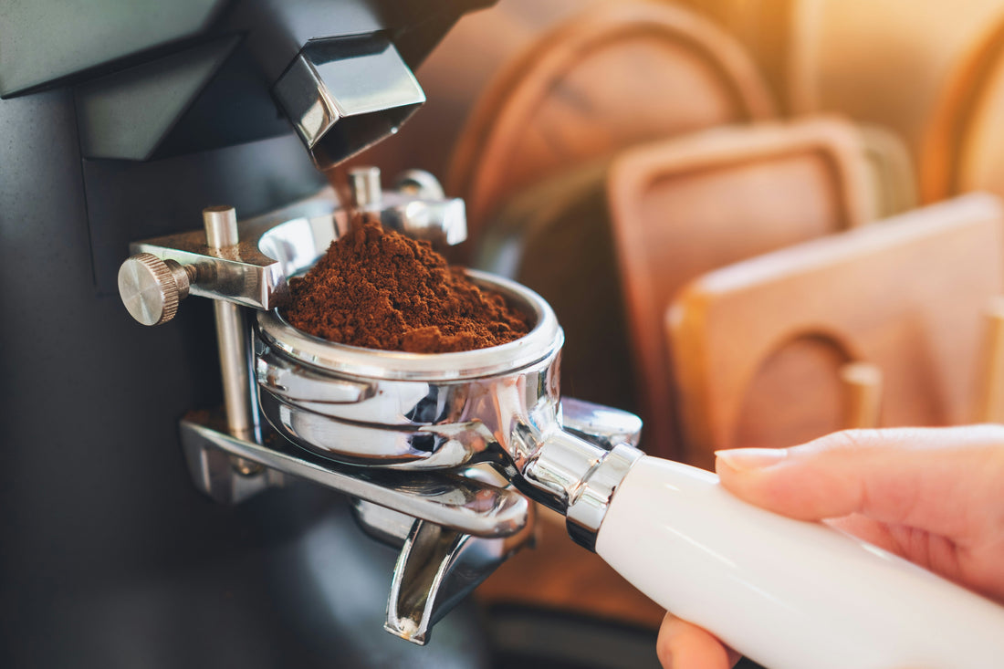 Freshly ground coffee falling from a grinder into a portafilter — Photo: Nguyen Tong Hai Van on Unsplash