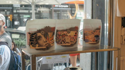 Tosco Fino coffee bags with artist artwork in the Barcelona café window — Filter Coffee Subscription, Roaster's Choice