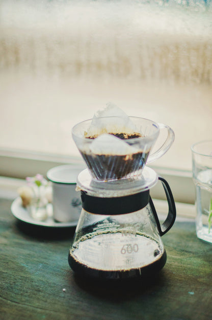 Pour-over dripper brewing into a glass carafe — Filter Coffee Subscription, Roaster's Choice. Photo: Anshu A on Unsplash