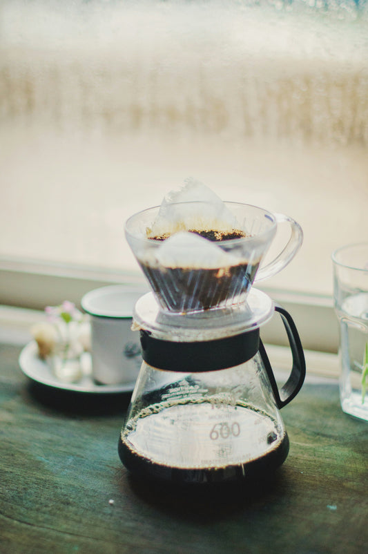 Pour-over dripper brewing into a glass carafe — Filter Coffee Subscription, Roaster's Choice. Photo: Anshu A on Unsplash