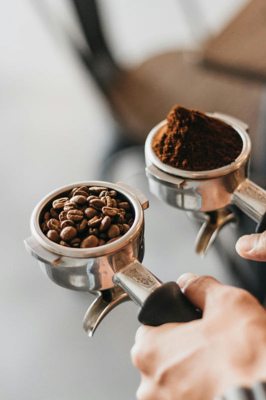 Two portafilters with whole beans and freshly ground espresso — Espresso Coffee Subscription, Roaster's Choice. Photo: Zarak Khan on Unsplash